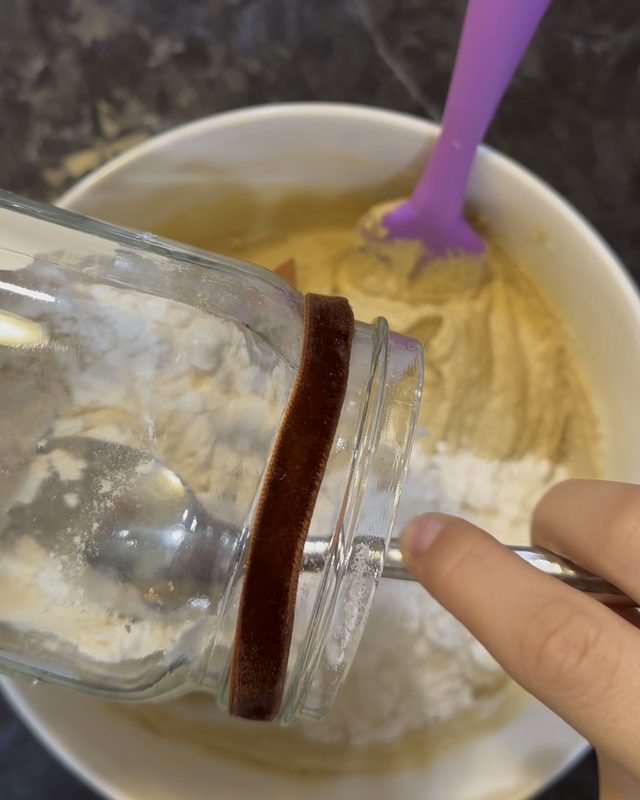 Katherine pouring a Katherine's Cookie Jar mix into the bowl