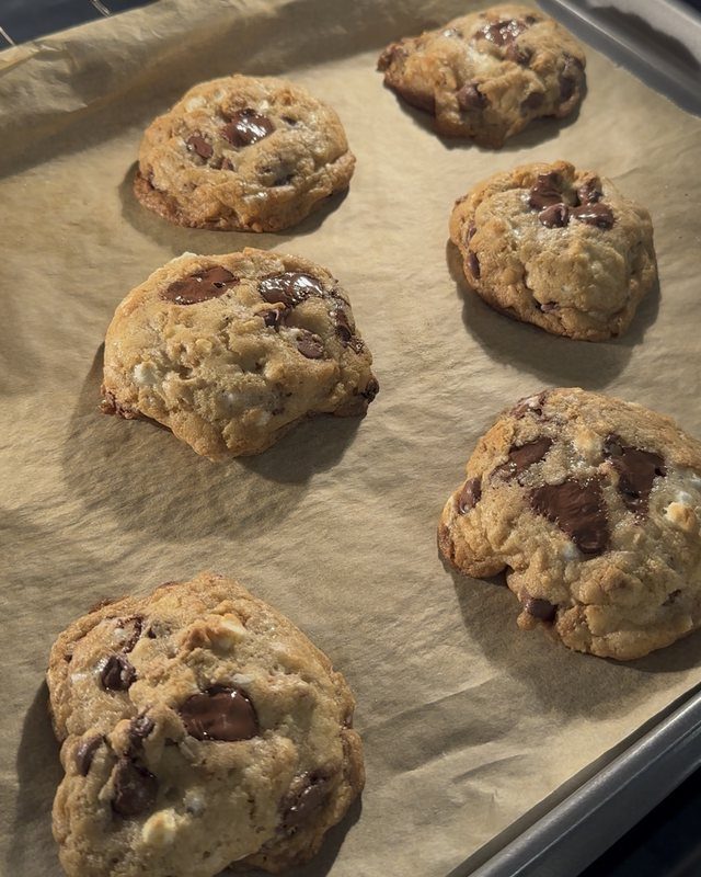 A tray of golden S'mores cookies with melted chocolate, just out of the oven
